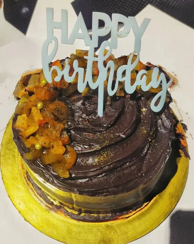 Dark chocolate ganache cake topped with candied fruit
