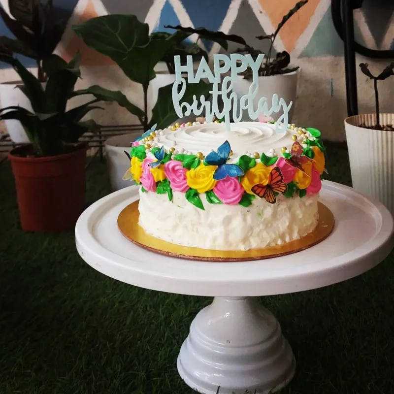 Birthday cake with piped buttercream roses and butterflies